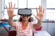 © WavebreakMediaMicro - Young girl interacting with virtual environment at classroom desk, wearing virtual reality headset