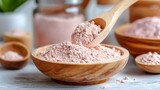 Clay mask being mixed with rose water in wooden bowl, powder swirls visible