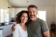© Vorda Berge - Portrait of a smiling middle age Hispanic couple in empty home after moving in