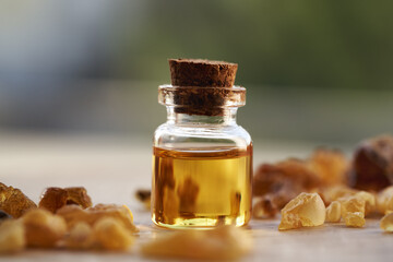 Wall Mural - A bottle of frankincense essential oil with frankincense resin