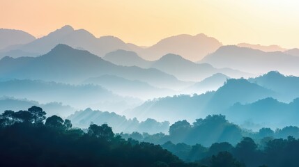 Poster - Stunning mountain range at sunrise reveals golden light through morning mist over tranquil peaks