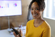 © Wavebreak Media - Mid adult woman holding tablet in office meeting room, presenting colorful monitor charts