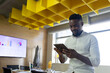 © Wavebreak Media - Mid adult African American man using tablet in meeting room with chart display, copy space
