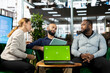 © DC Studio - Green screen laptop in front of businesspeople talking in startup company, looking at financial business documents. Chroma key notebook used by diverse team of office clerks