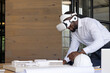 © Wavebreak Media - Young adult African American man examining scale model with VR headset in modern office, copy space