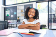 © Wavebreak Media - Girl child smiling while drawing with colored pencils at classroom desk, enjoying creative lesson
