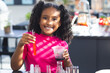 © Wavebreak Media - Child performing home kitchen experiment mixing orange liquid in test tube and using measuring cup