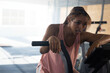 © Wavebreak Media - woman cycling on stationary exercise bike in indoor gym, dripping sweat and catching breath