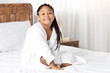 © Prostock-studio - Beautiful cute little african american girl in bathrobe relaxing on bed at home after shower, cheerful black kid enjoying spa beauty treatments, smiling and looking at camera, copy space