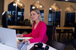 © Wavebreak Media - woman working on laptop at white desk in modern coworking office, with brass lamp