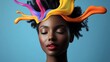 © Trushchenko_O - Woman with a colorful headpiece is looking at the camera. Concept of creativity and individuality, as the woman's unique hairstyle and colorful accessories stand out against the blue background