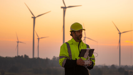 Aufkleber - Engineers male flying drone surveying and checking wind turbines from the high angle view of the field during beautiful sunset. using drone technology for work.