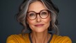 © Trushchenko_O - Woman with glasses and a yellow shirt. She is smiling and looking at the camera. Concept of warmth and friendliness