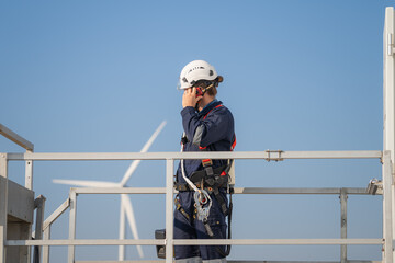Aufkleber - Engineer man working at windmill farm Generating electricity clean energy. Wind turbine farm generator by alternative green energy.