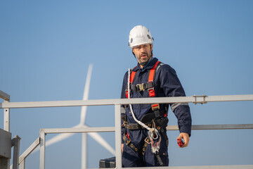 Aufkleber - Engineer man working at windmill farm Generating electricity clean energy. Wind turbine farm generator by alternative green energy.