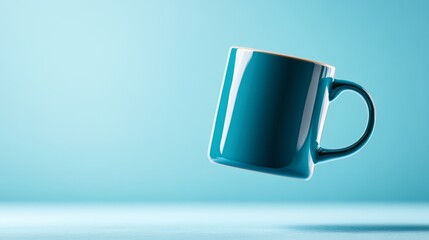 Poster - Blue coffee cup is floating in the air. The cup is empty and has a clear glass surface. The image has a calm and serene mood, as the cup is suspended in mid-air, seemingly defying gravity