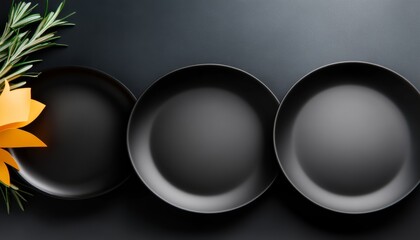 Poster - Three black plates with a yellow flower in the middle. The plates are empty and the flower is placed on top of them