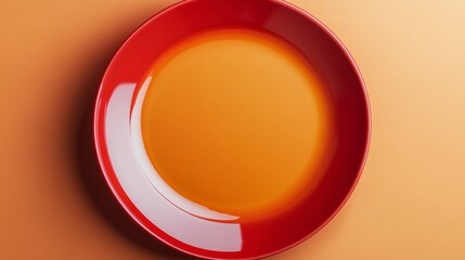 Poster - Red plate with a white rim sits on a tan background. The plate is empty and the rim is shiny