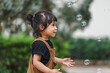 © geargodz - toddler girl playing soap bubble in park