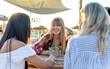 © Vittorio Gravino - Friends enjoying cocktails at beach bar: sharing laughter and summer vibes. Three women are laughing and enjoying refreshing cocktails at a beach bar, embracing the summer spirit