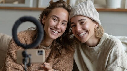 Poster - Two friends are smiling brightly while connecting virtually in a warm, eco-conscious living room. The cozy atmosphere is enhanced by elements of nature, creating a heartwarming vibe