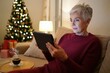 © alisaaa - Mature woman using digital tablet for online Christmas shopping