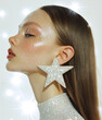© Boadicea - Fashion model wearing big star-shaped earrings and glitter make-up