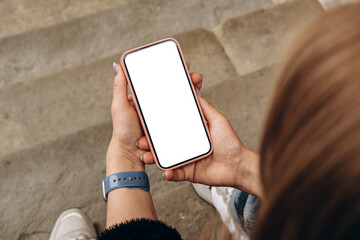 Mockup woman's hand holding using smart phone with white blank screen POV  mobile app design and advertising, online marketing