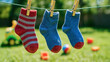 © newlifestock - Brightly colored socks hang on clothesline under sun symbolizing family life and shared goals in playful outdoor setting