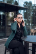 © RomanR - successful young business woman talking  phone cellphone while walking outdoor, near business centr
