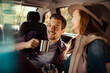 © Davor - Happy couple drinking coffee and relaxing in the back of their car on a road trip