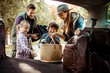 © Davor - Family packing car trunk together for weekend road trip adventure
