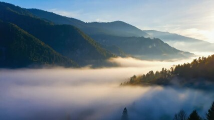 Aufkleber - Fog rolling across a valley with sunbeams breaking through.

