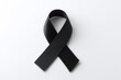 © Andrei - solitary black ribbon on plain white background symbolizes mourning and remembrance