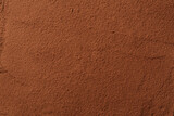 Cocoa powder background. Organic food with useful properties. Top view of cocoa texture