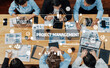 © InfiniteFlow - A diverse team engaged in a project management meeting, analyzing data and discussing strategies for effective resource allocation and risk assessment in a modern office setting. Amity