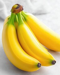 Poster - Two vibrant bananas resting on a white table showcasing their natural beauty in simple elegance