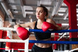 © New Africa - Woman with protective gloves on boxing ring