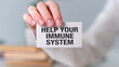 © Pawel - A person is holding a card that says Help Your Immune System
