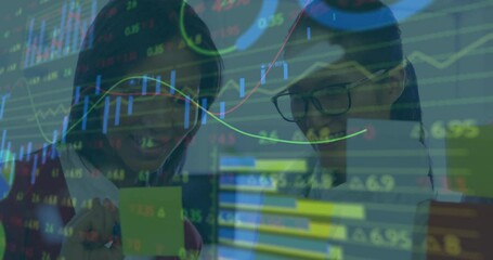 Poster - Two women leaning over desk pointing at sticky note showing finance line graphs and candlesticks