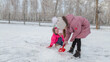 © Mariia - Children playing in snowy park winter time
