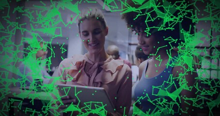 Poster - Two women collaborating on tablet in office, showing technology network overlay connecting data