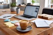 © Garik - Work setup with coffee, laptop, and stationery in a bright interior setting during the daytime