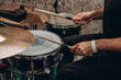 © Anton Pentegov - drummer plays drumset with wooden drum sticks, close-up view of hands