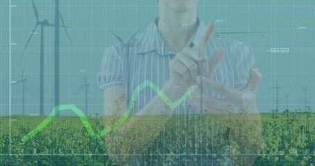 Poster - woman gesturing with virtual chart overlay in farm tech, showing green line graph and wind turbines