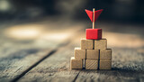 Targeting. Pyramid of cubes with arrows pointing to one on top on wooden background