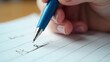 © Ernesto - Macro shot of a blue pen writing. Ink sheen, paper fibers, and tiny fingers showcase focused learning in vivid detail.
