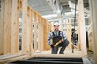© Serhii - A carpenter works on the construction of modular houses