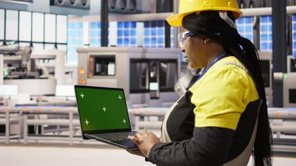 Poster - technician in industrial plant using green screen laptop to diagnose equipment errors. factory speci
