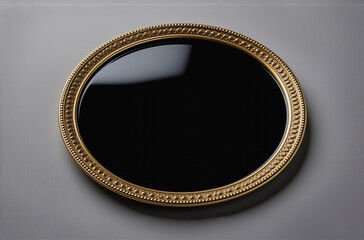 Poster - A circular, black reflective surface is encased in an ornate gold frame with beaded detailing.  The image is minimalist and elegant.